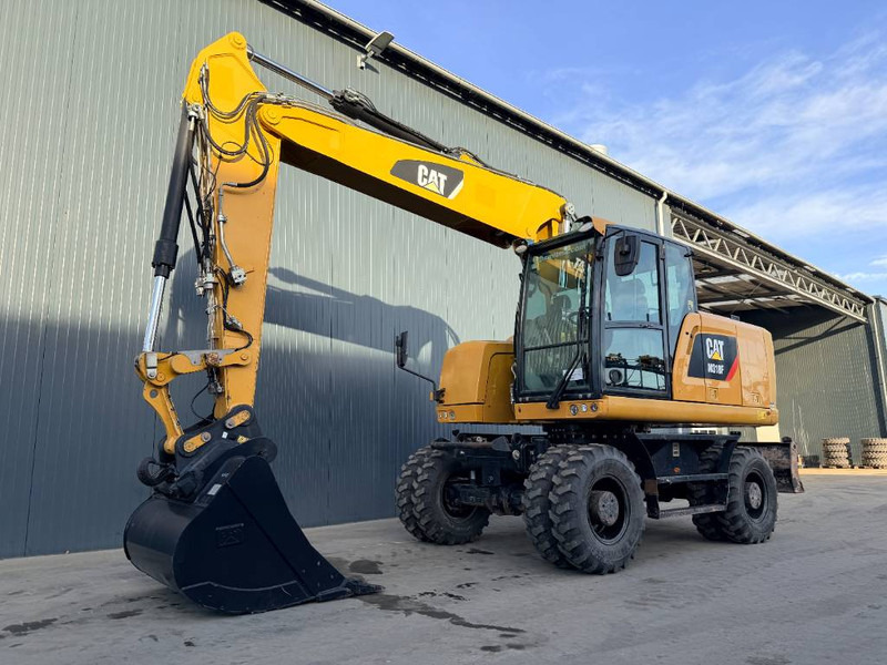 Cat M318F - מחפר גלגלים: תמונה 1 Cat M318F - מחפר גלגלים: תמונה 1