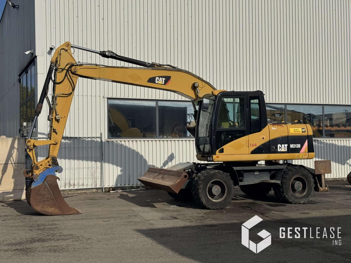 Caterpillar M313D - מחפר גלגלים: תמונה 1 Caterpillar M313D - מחפר גלגלים: תמונה 1