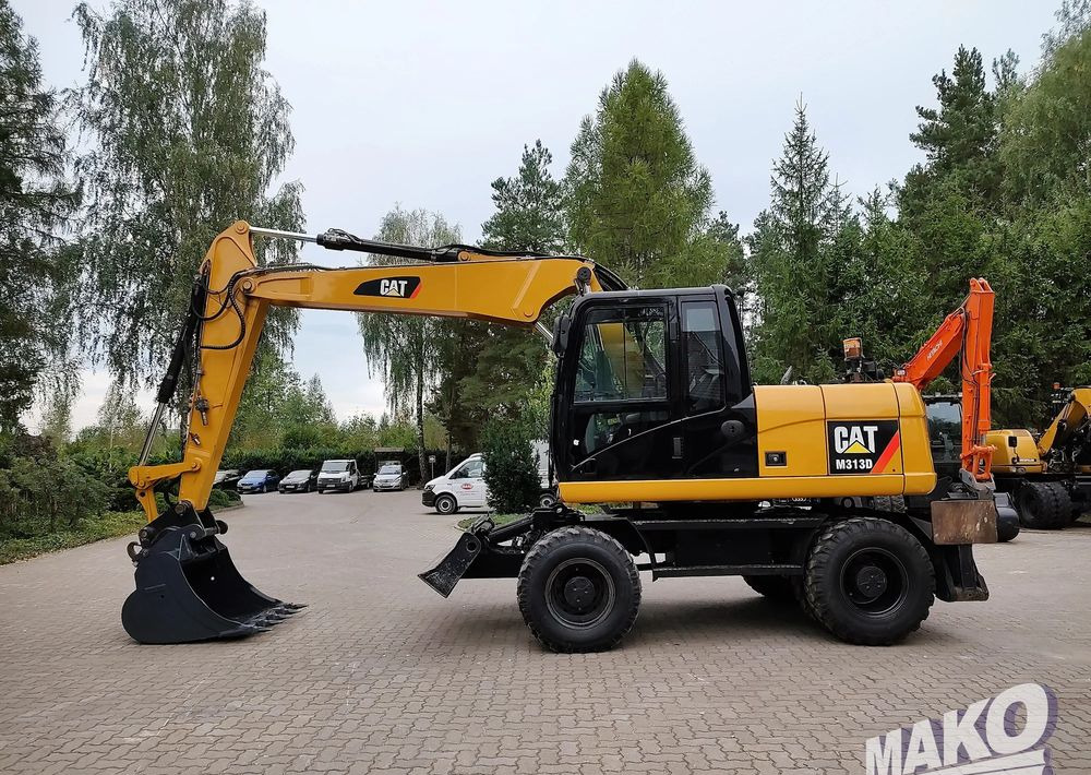 Caterpillar M313D - מחפר גלגלים: תמונה 1 Caterpillar M313D - מחפר גלגלים: תמונה 1