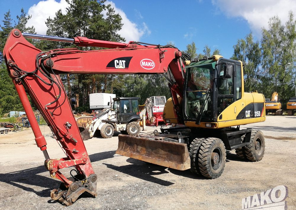 Caterpillar M315 C - מחפר גלגלים: תמונה 1 Caterpillar M315 C - מחפר גלגלים: תמונה 1