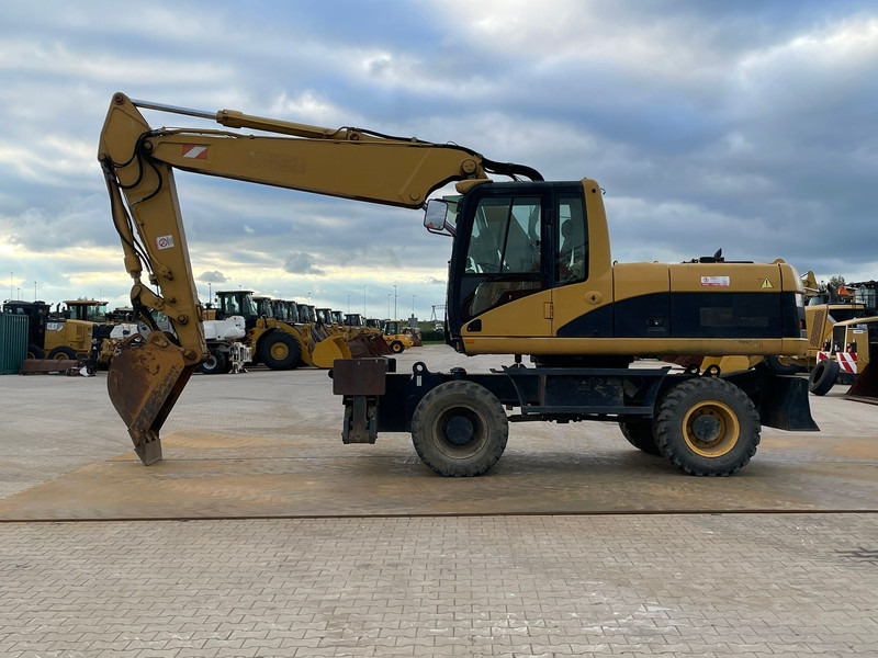 Caterpillar M318C - מחפר גלגלים: תמונה 1 Caterpillar M318C - מחפר גלגלים: תמונה 1