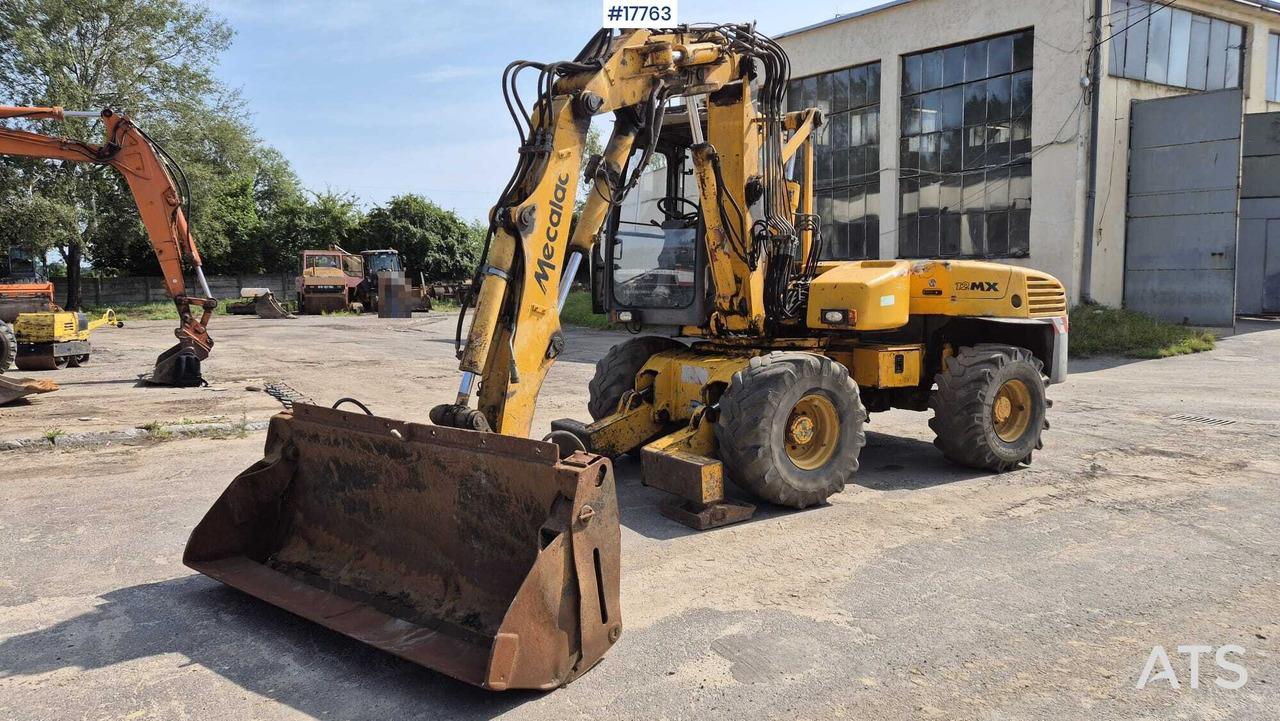 MECALAC 12MX wheeled excavator (1996) - מחפר גלגלים: תמונה 1 MECALAC 12MX wheeled excavator (1996) - מחפר גלגלים: תמונה 1