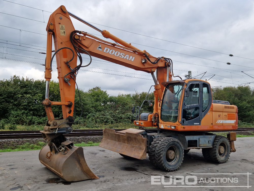 Doosan DX210W - מחפר גלגלים: תמונה 1 Doosan DX210W - מחפר גלגלים: תמונה 1